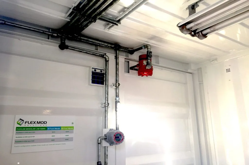 Overhead process piping and fire-suppression valve inside a C1D1 extraction lab